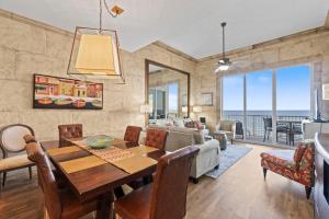 a dining room and living room with a table and chairs at Spanish Key 705 in Perdido Key