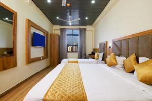 a bedroom with two beds and a flat screen tv at Hotel BKC Minerva, Near US Consulate in Mumbai +35 photos