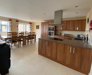 a kitchen with wooden cabinets and a dining room at Riff Farmhouse, ideal for exploring Orkney in Orkney