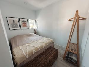 a bedroom with a ladder next to a bed at Casa da Aldeia in Alcácer do Sal +3 photos
