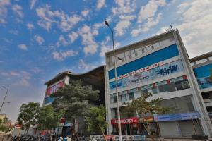 a building with a street light in front of it at Infinity Rooms D-Mart in Surat