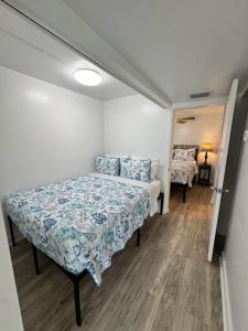 a bedroom with a bed with blue and white sheets at Unit 109 -1br Apt Oceanfront Complex With Pool in Cocoa Beach