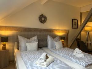a bedroom with two beds with towels on them at Weberhof - Münster 3 in Münster