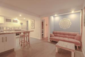 a kitchen and living room with a couch and a table at Charmant T2 à Sainte Luce in Sainte-Luce