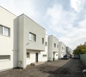 a row of white buildings on a street at Casa Magurele 3 in Măgurele