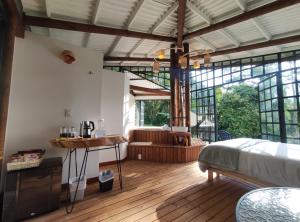 a bedroom with a bed and a wooden floor at Casa De La Ruta, Glamping in Zipacón