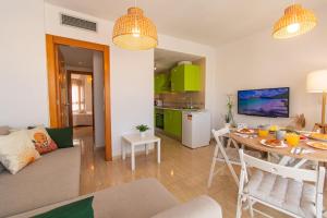 a living room with a table and a kitchen at La Terraza, Avenida Principal y junto a la Playa - by Aloha Palma in Águilas +33 photos