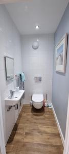 un bagno bianco con un water e un lavandino di Sunrise Cottage, 2 minutes walk from the beach! a Woodhorn Altre 14 foto