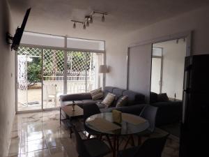 a living room with a couch and a table at APE Dream Villa in Itabo