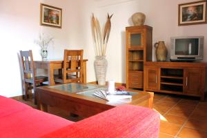 a living room with a coffee table and a tv at La Hacienda de Don Luis in Jimena de la Frontera