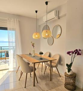 a dining room with a table and chairs at Ionelia Seaview Apartment at Barbati in Barbati
