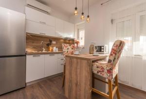 a kitchen with a wooden counter and a refrigerator at Apartment Julia A1 in Biograd na Moru