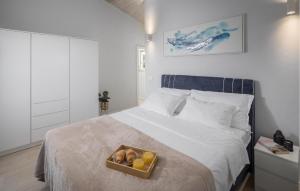 a bedroom with a bed with a tray of fruit on it at Amazing Home In Krsan in Kršan