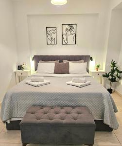 a bedroom with a large bed with a gray tufted bedskirts at Ionelia Seaview Apartment at Barbati in Barbati
