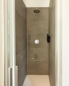 a shower stall in a bathroom with a shower at Naviglio suite apartments in Robecco sul Naviglio +44 photos