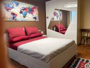 a bedroom with a bed with red pillows at B&B L'Argonauta in Cremona