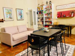 a living room with a couch and a table and chairs at B&B L'Argonauta in Cremona