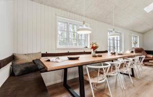 a dining room with a large wooden table and chairs at Stunning Home In Glesborg With Sauna in Glesborg