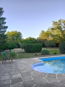 a patio with a bench and a swimming pool at Sauces Las Chacras in Juana Koslay 