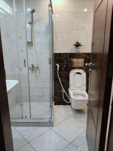 a bathroom with a shower and a toilet and a sink at B&B Homes in Abu Dhabi
