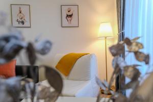 a living room with a couch and a lamp at Hana Plitvice Apartment in Korenica