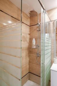 a shower with a glass door in a bathroom at FiveStepsToSea - Beach Apartment Valencia in Valencia +37 photos