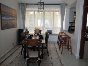 a living room with a dining room table and chairs at Beach Breeze 001 in Mombasa