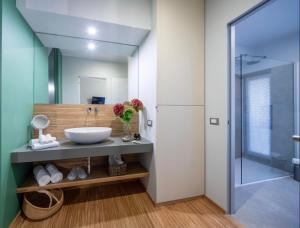 a bathroom with a sink and a shower at 30Cavour luxury suites in Pavia +39 photos