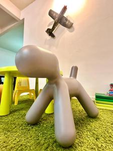 a toy airplane flying over a table and a chair at The Yew Homestay in Teluk Intan