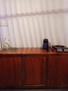 a wooden counter top with a coffee maker on it at Holiday Beach Cottage in Ahangama +5 photos