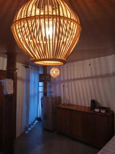 a large chandelier hanging from the ceiling in a room at Holiday Beach Cottage in Ahangama