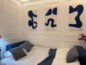 パリにあるAppartement parisien chic & cosy MBKAの青い看板が壁に施されたベッドルーム
