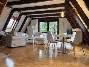 a living room with a table and chairs at Eifelwolke in Kerschenbach
