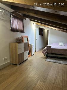 a bedroom with a bed and a dresser in a room at Principal Plaza in Salamanca