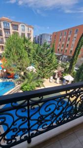 a balcony with a view of a pool and buildings at Апарамент за гости Романс Марин in Sunny Beach