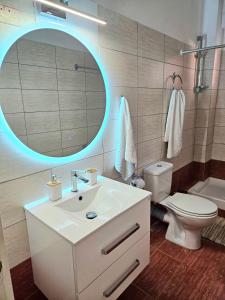 a bathroom with a sink and a mirror and a toilet at Ionelia Seaview Apartment at Barbati in Barbati +19 photos