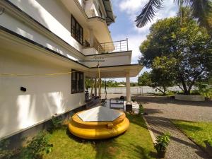 a large wooden boat sitting in the yard of a house at The Riverview Residency-Waterfront Pool Villa,Chirayam, Ernakulam in Ernakulam