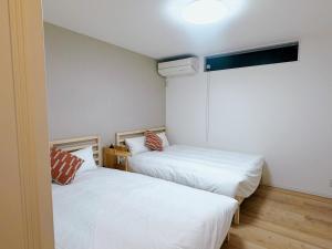 Postel nebo postele na pokoji v ubytování 和悦岸里玉出