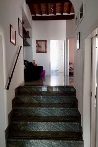 a hallway with a staircase in a house at Historic Center Apartment with Private Garage in Montalcino