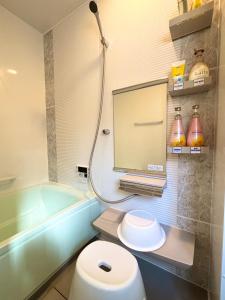 a bathroom with a toilet and a bath tub at 2024 Renovation house hanasaki in Takayama +25 photos