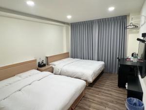 Postel nebo postele na pokoji v ubytování 悦心旅Yesing Hotel