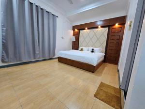 a bedroom with a bed and a large window at Grace Homestay in Kudat