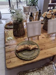 a wooden table with a plate on top of it at Mohau Accommodation and Events - South Africa in Elandsfontein