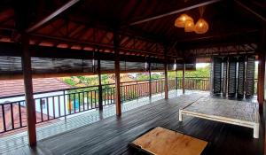 a pavilion with a bench on a wooden floor at Casa Shanti in Nusa Dua