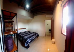 a small bedroom with a bed and a doorway at Casa Shanti in Nusa Dua