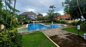 a swimming pool in the yard of a house at Casa Shanti in Nusa Dua