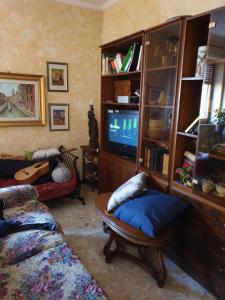 a living room with a tv and a couch and a chair at eleonora in Grottammare