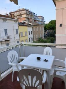 a white table and chairs on a balcony at eleonora in Grottammare