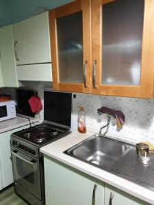 a kitchen with a sink and a stove at eleonora in Grottammare