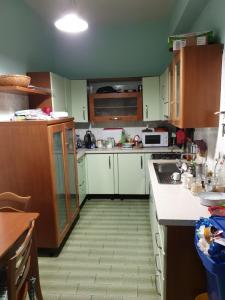 a kitchen with white counters and wooden cabinets at eleonora in Grottammare +4 photos